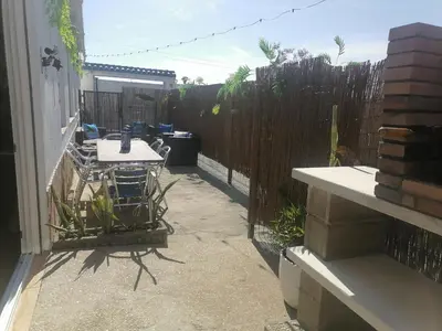 a patio with a table and a fence at Mis Princesas en Casablanca in Chiclana de la Frontera