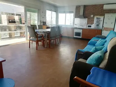 a living room with a couch and a table and chairs at Mis Princesas en Casablanca in Chiclana de la Frontera