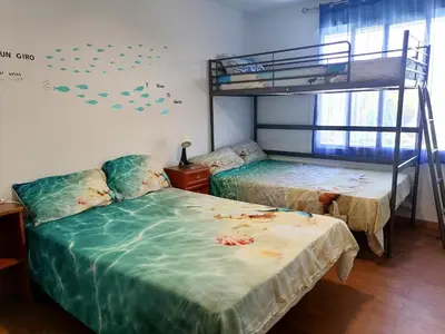 a bedroom with two beds and a bunk bed at Mis Princesas en Casablanca in Chiclana de la Frontera