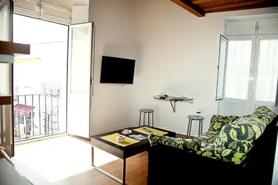 a living room with a couch and a table at Apartamentos La Casa de la Alameda in Medina Sidonia