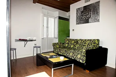 a living room with a couch and a table at Apartamentos La Casa de la Alameda in Medina Sidonia