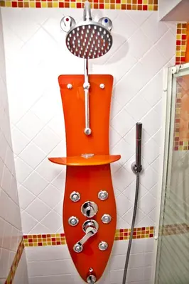 a shower in a bathroom with an orange shower head at Apartamentos La Casa de la Alameda in Medina Sidonia