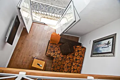 a living room with a couch and a window at Apartamentos La Casa de la Alameda in Medina Sidonia