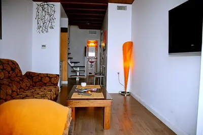 a living room with a couch and a coffee table at Apartamentos La Casa de la Alameda in Medina Sidonia