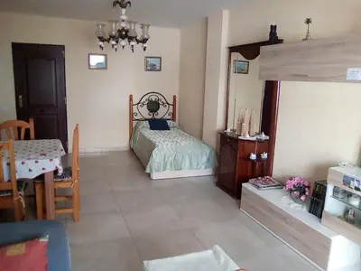 a bedroom with a bed and a table and a chair at Azul Maritimo in Cádiz