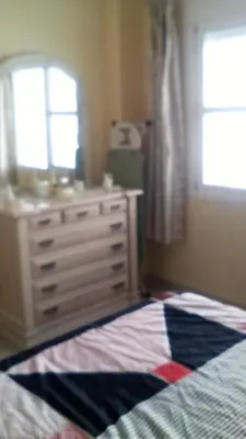 a bedroom with a bed and a dresser and a window at Azul Maritimo in Cádiz