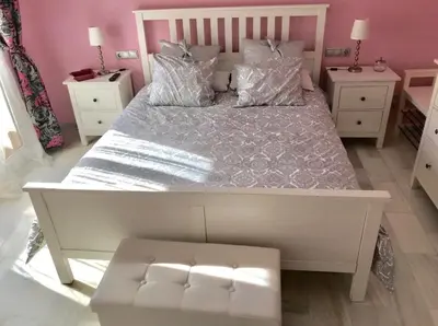 a bedroom with a large white bed with pink walls at PuertoHouse in El Puerto de Santa María