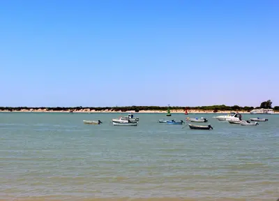 a group of boats sitting in the water at Vivienda Avenida de la Manzanilla in Sanlúcar de Barrameda