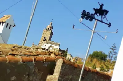 a church on top of a wall with a cross at Posada Alegria in Medina Sidonia