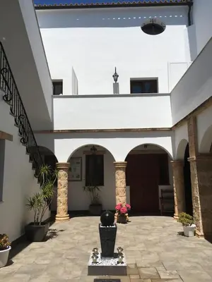 a courtyard of a house with a staircase at Posada Alegria in Medina Sidonia