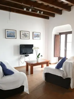 a living room with two chairs and a tv at Posada Alegria in Medina Sidonia
