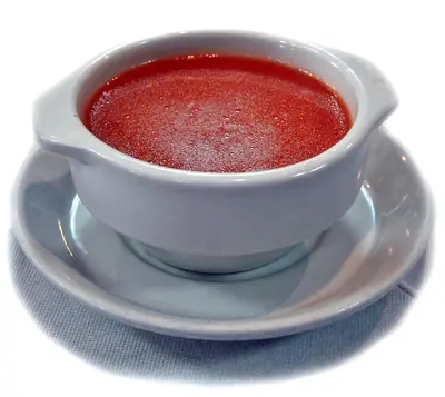 a cup of red sauce sitting on a plate at Pensión San Marcos in Arcos de la Frontera