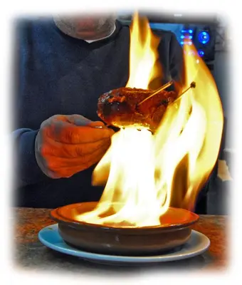 a man is eating a piece of food on a plate at Pensión San Marcos in Arcos de la Frontera