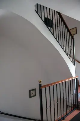 a staircase with a white wall and a stair case at Pensión San Marcos in Arcos de la Frontera