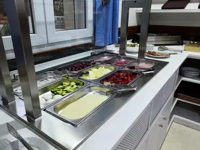 a buffet line with many different types of food at Hotel Marisma Sancti Petri in Chiclana de la Frontera
