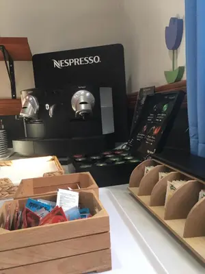 a espresso machine with two boxes on a table at Hotel Marisma Sancti Petri in Chiclana de la Frontera