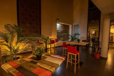 a living room with a table and chairs and plants at Hotel Los Nardos in Chipiona