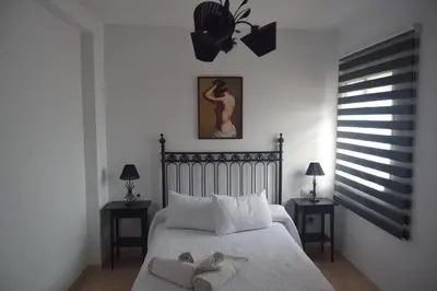 a bedroom with a bed with two towels on it at Downtown house centro histórico in Arcos de la Frontera