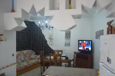 a living room with a table and a tv at Downtown house centro histórico in Arcos de la Frontera