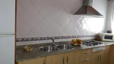 a kitchen counter with a sink and a microwave at Apartamento centro histórico Arcos in Arcos de la Frontera