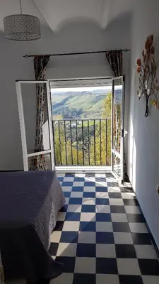 a bedroom with a bed and a checkered floor at Apartamento centro histórico Arcos in Arcos de la Frontera