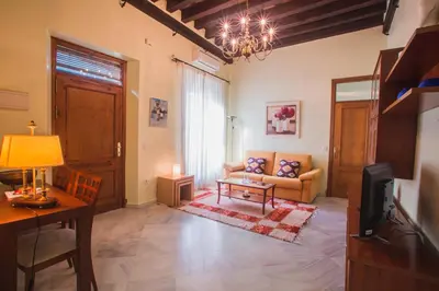 a living room with a couch and a table at Atico Cielos 102 in El Puerto de Santa María