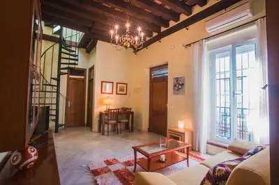 a living room with a couch and a table at Atico Cielos 102 in El Puerto de Santa María