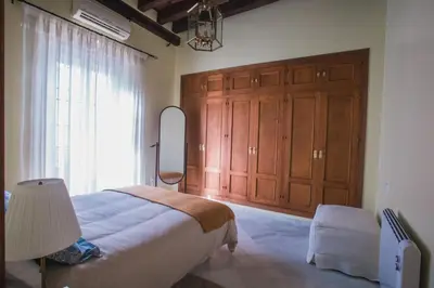 a bedroom with a bed and a large window at Atico Cielos 102 in El Puerto de Santa María