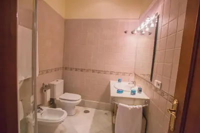 a bathroom with a toilet and a sink at Atico Cielos 102 in El Puerto de Santa María