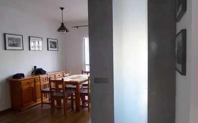 a kitchen and dining room with a table and chairs at Precioso duplex con piscina en Real de la Barrosa in Chiclana de la Frontera
