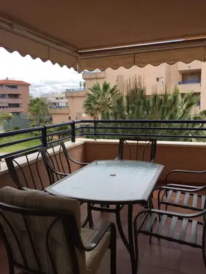 a table and chairs on a balcony with a view at Apartamento Julieta in Sanlúcar de Barrameda