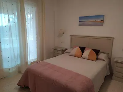 a bedroom with a bed with two pillows on it at Apartamento Julieta in Sanlúcar de Barrameda