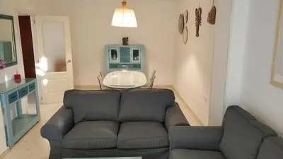 a living room with a couch and a table at Apartamento Julieta in Sanlúcar de Barrameda