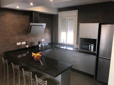 a kitchen with a island with a bowl of fruit on it at Avenida de las Piletas in Sanlúcar de Barrameda