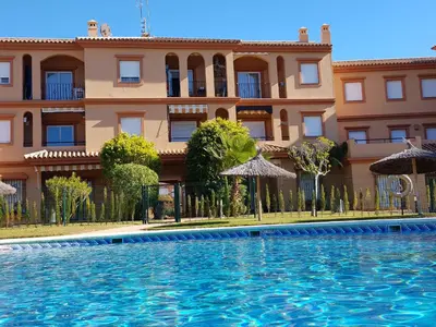 a swimming pool in front of a building at Novo Paradise in Chiclana de la Frontera
