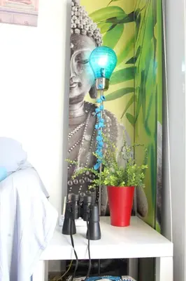 a painting of a woman on a wall with a plant at Cosy apartment with sea view in Chipiona - 50 m² in Chipiona