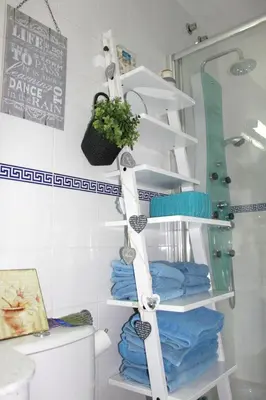 a bathroom with a white towel rack next to a toilet at Cosy apartment with sea view in Chipiona - 50 m² in Chipiona