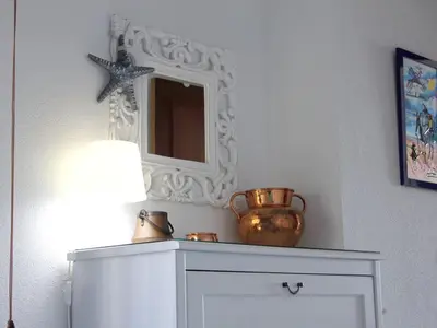 a room with a mirror and a vase on a dresser at Cosy apartment with sea view in Chipiona - 50 m² in Chipiona