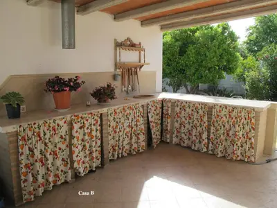 a table covered with a floral table cloth on a patio at Alojamiento rural 