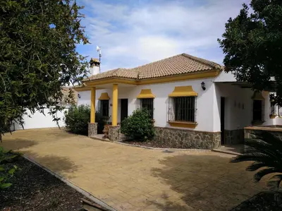 a white house with yellow columns at Alojamiento rural 