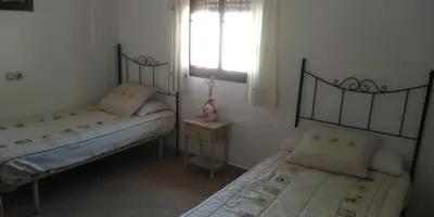 a bedroom with two beds and a window and a window at Alojamiento rural 