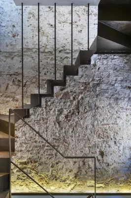 a staircase in a building with a stone wall at Casa La Muralla MEDIEVAL by Cadiz4Rentals in Cádiz