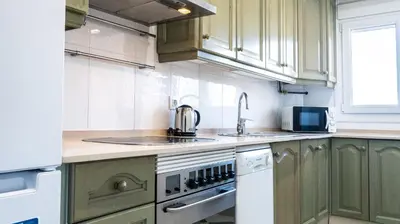 a kitchen with green cabinets and a sink at Apartamento Cadiz Paradiso in Cádiz