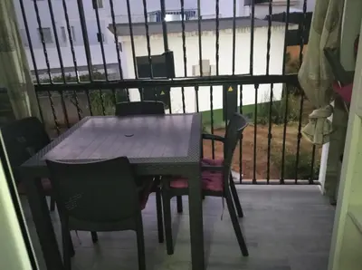 a table and chairs on a balcony with a fence at Apartamento La Gaviota in Chipiona