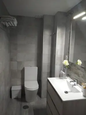 a bathroom with a toilet and a sink at Apartamento La Gaviota in Chipiona