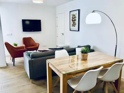 a living room with a table and a couch at Apartamento Ecuador in Cádiz