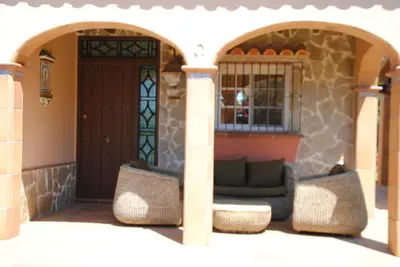 a front porch of a house with a couch at Villa Solea in Chiclana de la Frontera