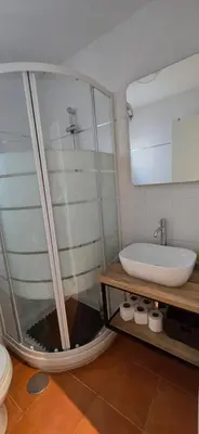 a bathroom with a tub and a sink and a mirror at Apartamento Arbolí in Cádiz