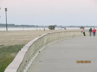 a bridge over a beach with people walking on it at CALLE YERBABUENA 5 in Sanlúcar de Barrameda