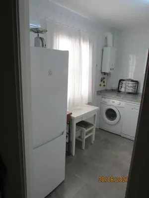 a kitchen with a white refrigerator and a washing machine at CALLE YERBABUENA 5 in Sanlúcar de Barrameda